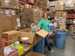 A volunteer sorts supplies.