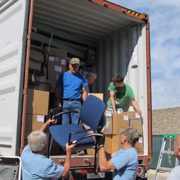 Volunteers load a shipment onto a truck.